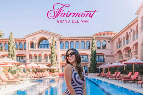 Woman smiling by the pool at Fairmont Grand Del Mar, NYC web designer and video editor.